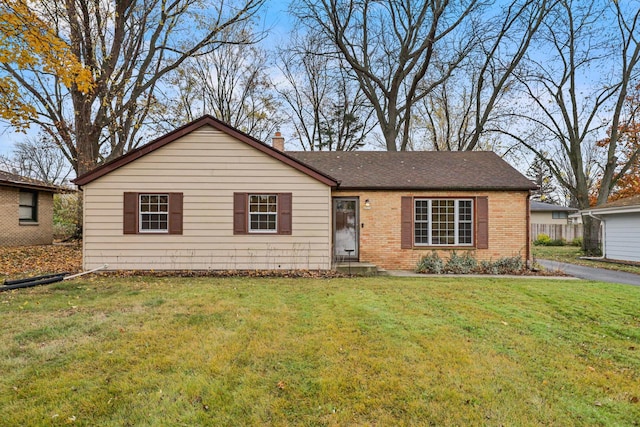 ranch-style home with a front lawn