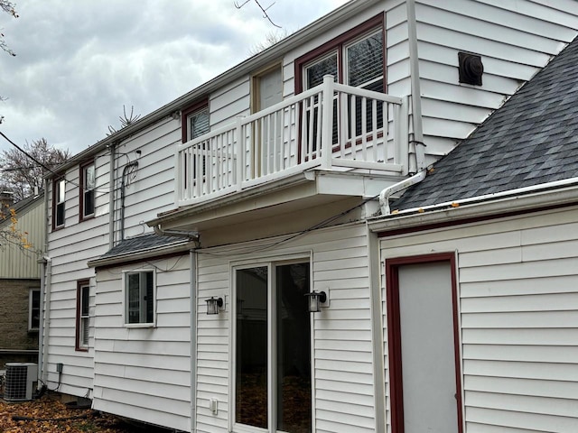 view of side of property with a balcony and cooling unit