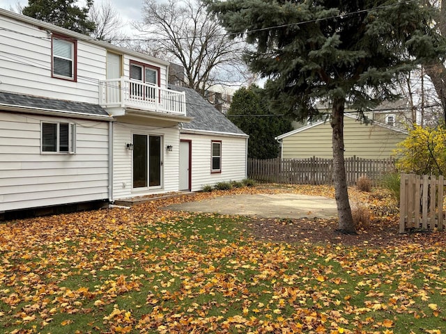 rear view of property with a patio and a balcony