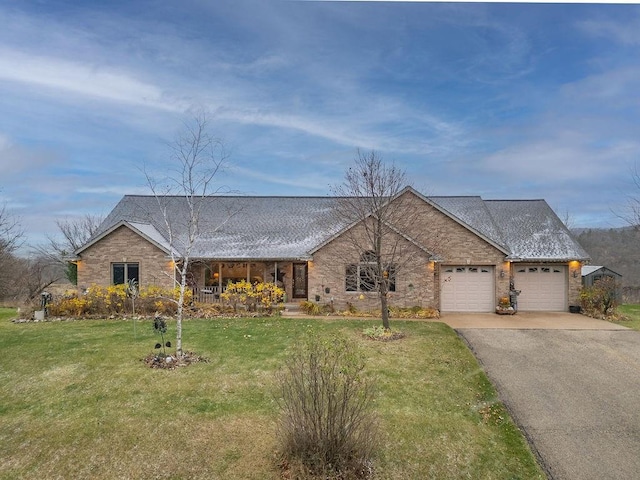 single story home featuring a garage and a front lawn