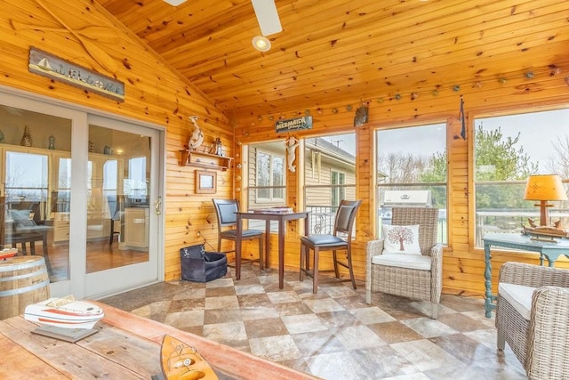 sunroom / solarium featuring vaulted ceiling, a wealth of natural light, and wood ceiling