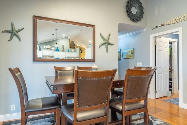 dining area with hardwood / wood-style flooring and lofted ceiling