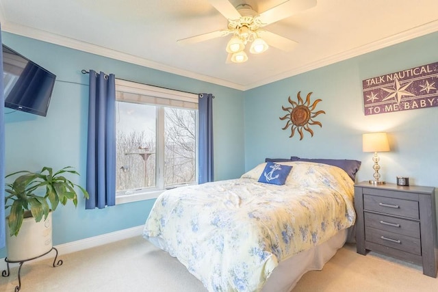 carpeted bedroom with ceiling fan and crown molding