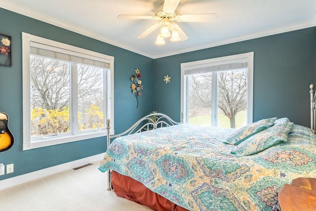 bedroom featuring multiple windows, carpet flooring, ceiling fan, and crown molding