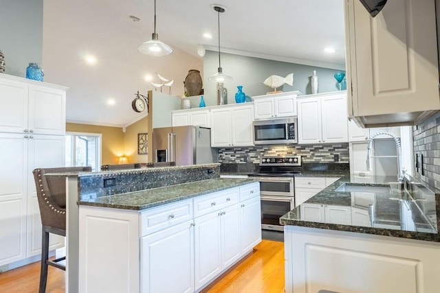 kitchen featuring white cabinetry, a kitchen island, and appliances with stainless steel finishes