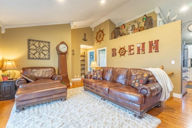 living room with vaulted ceiling, light hardwood / wood-style flooring, and crown molding