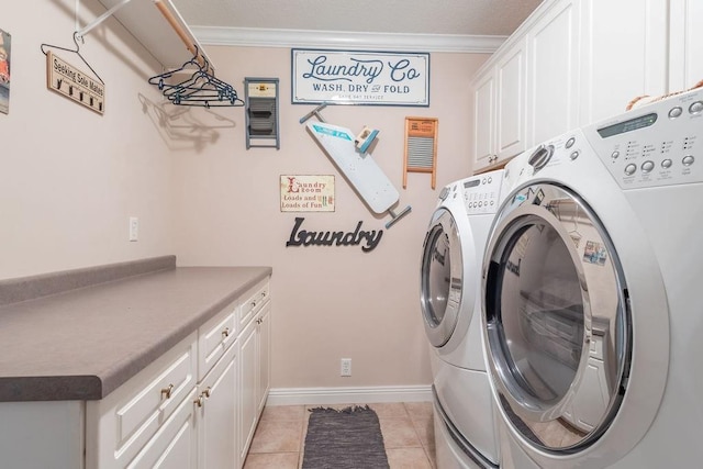 washroom featuring cabinets, light tile patterned floors, washing machine and dryer, and ornamental molding