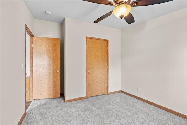 unfurnished bedroom featuring ceiling fan and light carpet