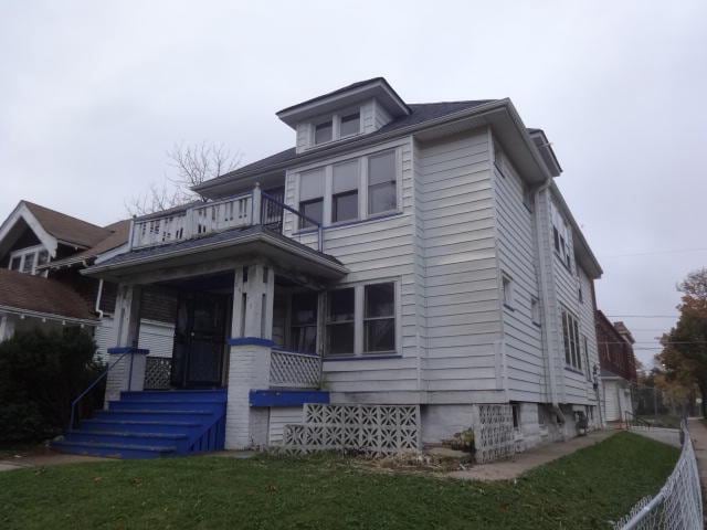 2977 N 26th St Unit 2979, Milwaukee, WI 53206 - traditional style home featuring a balcony, covered porch, and a front lawn
