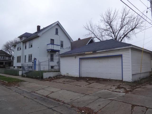 2977 N 26th St Unit 2979, Milwaukee, WI 53206 - view of front of home featuring a detached garage, an outbuilding, and a chimney