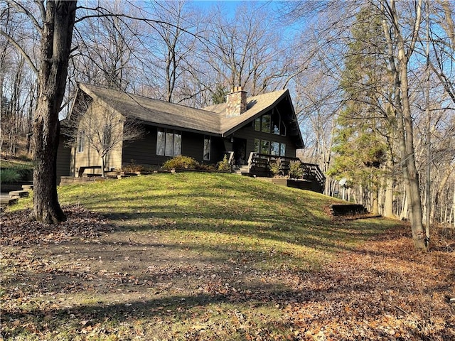 exterior space with a wooden deck and a front lawn