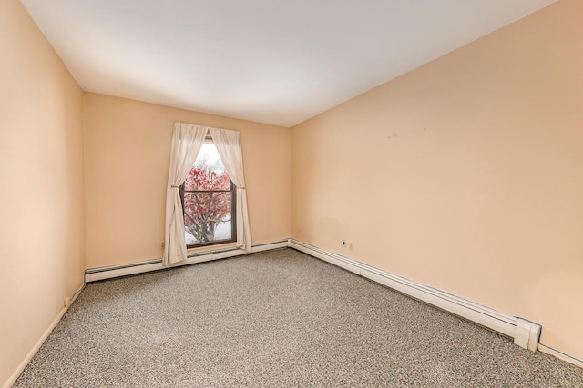 empty room with carpet and a baseboard heating unit