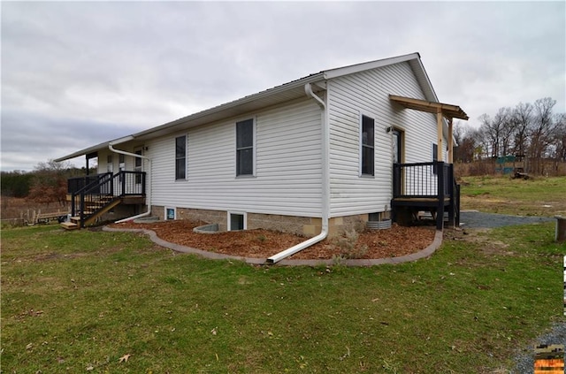 view of side of home with a lawn