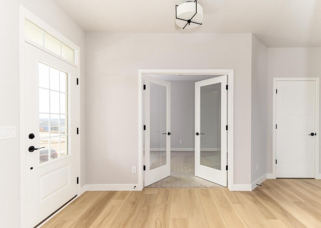 entryway featuring french doors and light wood-type flooring