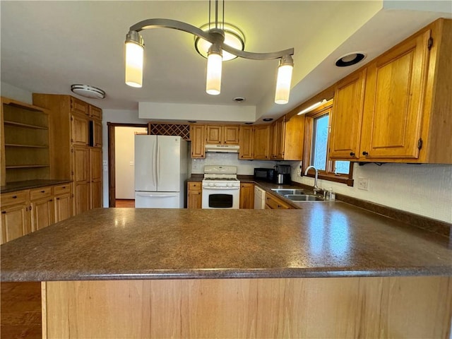 kitchen with kitchen peninsula, white appliances, backsplash, and sink