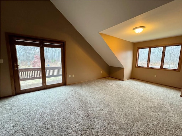 bonus room with carpet flooring, lofted ceiling, and a wealth of natural light