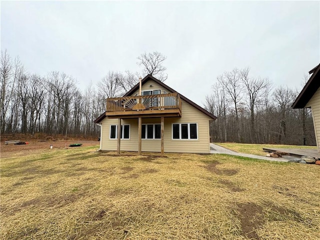 back of property with a lawn and a wooden deck