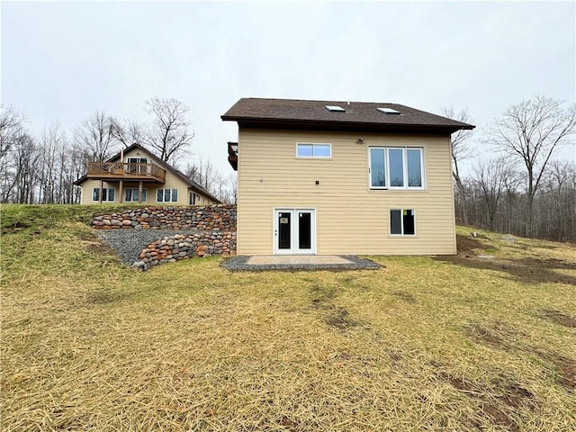 back of house featuring a patio and a lawn