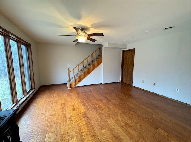 unfurnished living room with hardwood / wood-style flooring and ceiling fan