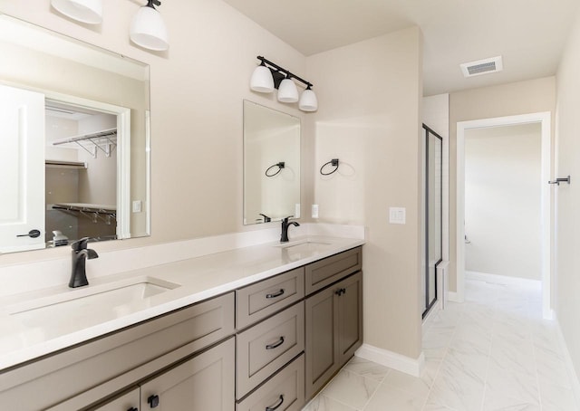 full bath featuring marble finish floor, visible vents, a sink, and a stall shower