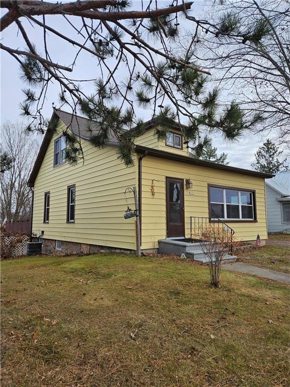 bungalow-style home with a front yard