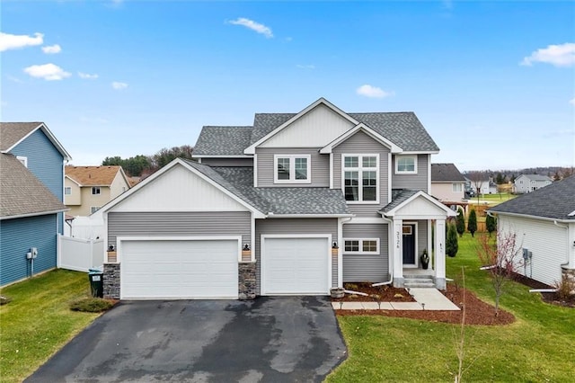 view of front of home featuring a front lawn and a garage