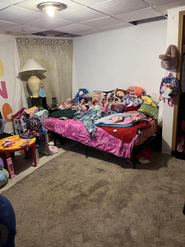 carpeted bedroom with a drop ceiling