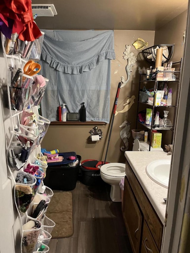 bathroom with tile patterned flooring, vanity, and toilet