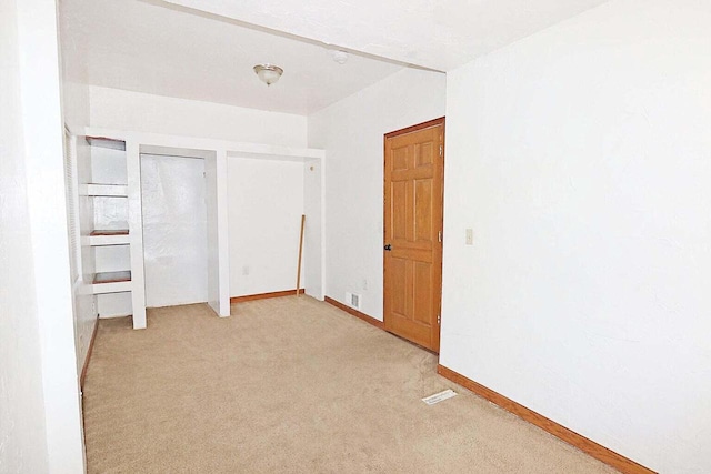 unfurnished bedroom with light colored carpet