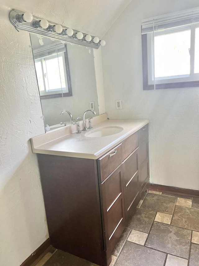 bathroom featuring vanity and vaulted ceiling