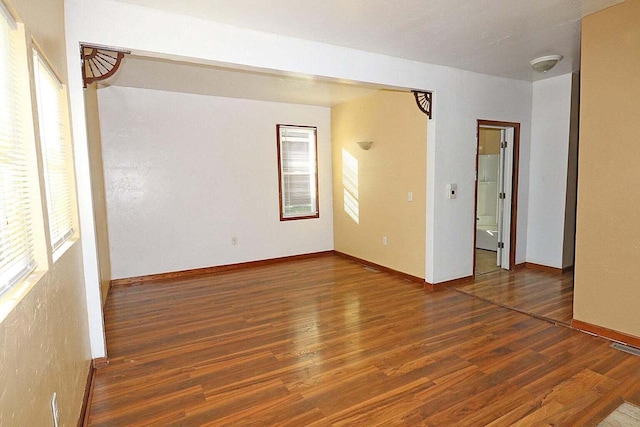 spare room featuring dark wood-type flooring