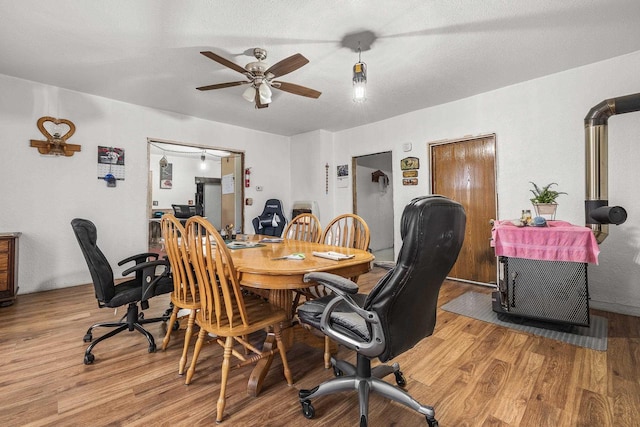 office space with ceiling fan, a textured ceiling, and light hardwood / wood-style flooring