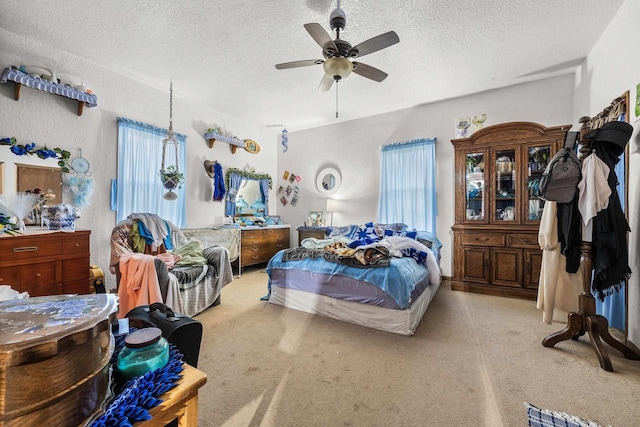 bedroom featuring ceiling fan and a textured ceiling