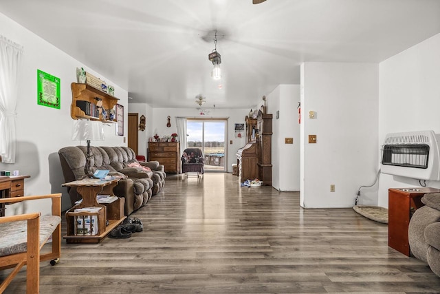 living room featuring heating unit and wood-type flooring