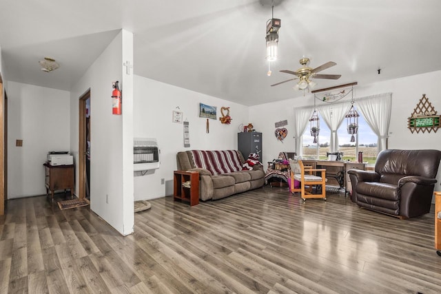 living room featuring ceiling fan, heating unit, and hardwood / wood-style floors