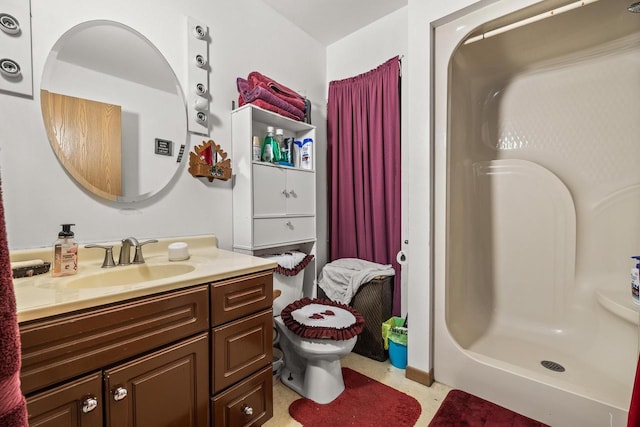 bathroom featuring a shower, toilet, and vanity