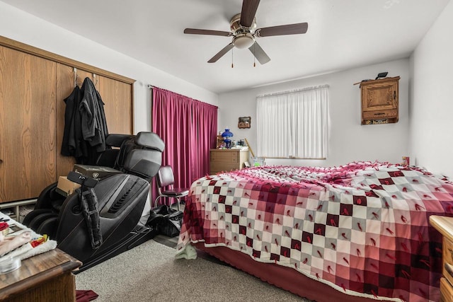 carpeted bedroom featuring ceiling fan and a closet