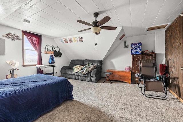 carpeted bedroom with ceiling fan, vaulted ceiling, and wooden walls