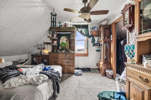 bedroom with ceiling fan, carpet, a closet, a textured ceiling, and vaulted ceiling