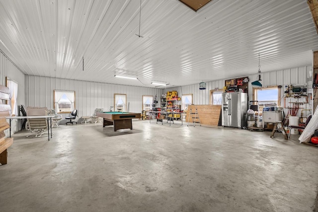 garage featuring stainless steel fridge with ice dispenser