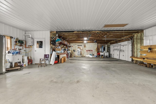 garage with water heater and a workshop area