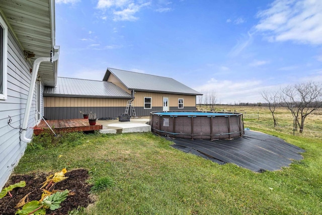 view of yard featuring a swimming pool side deck and a rural view