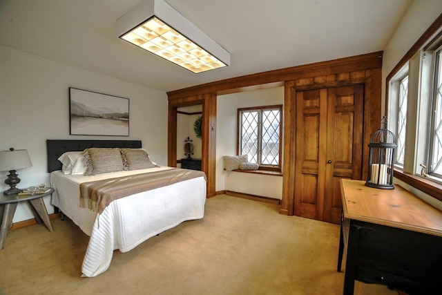 613 College St, Beloit, WI 53511 - bedroom featuring multiple windows, light colored carpet, and baseboards