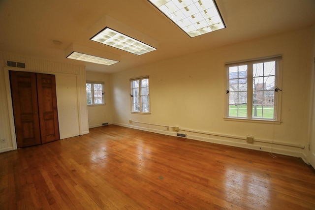 613 College St, Beloit, WI 53511 - empty room featuring hardwood / wood-style floors and baseboards