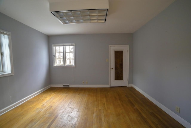 613 College St, Beloit, WI 53511 - empty room featuring hardwood / wood-style flooring and baseboards