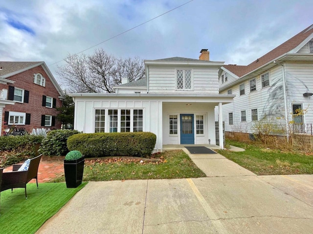 613 College St, Beloit, WI 53511 - view of front of property with a chimney and board and batten siding