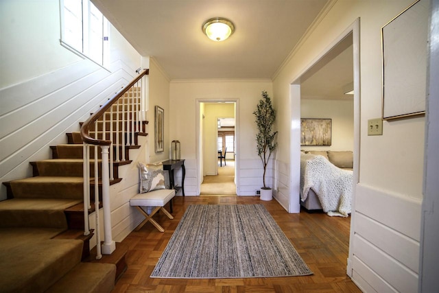 entrance foyer with dark parquet floors and ornamental molding