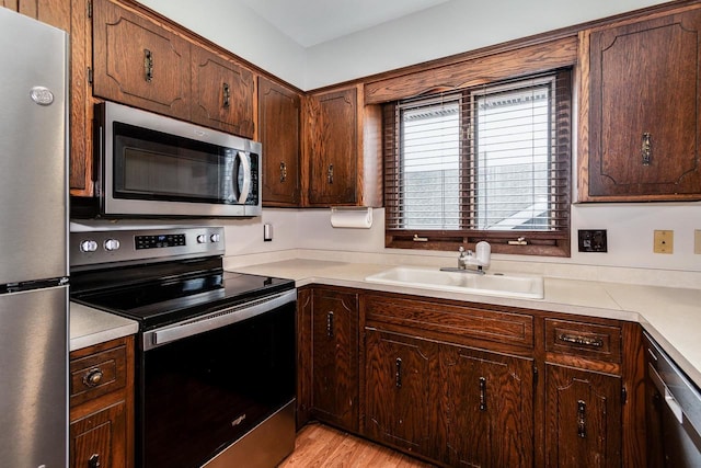 kitchen featuring sink, light hardwood / wood-style flooring, and stainless steel appliances