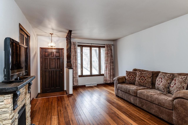 living room with a fireplace and dark hardwood / wood-style flooring