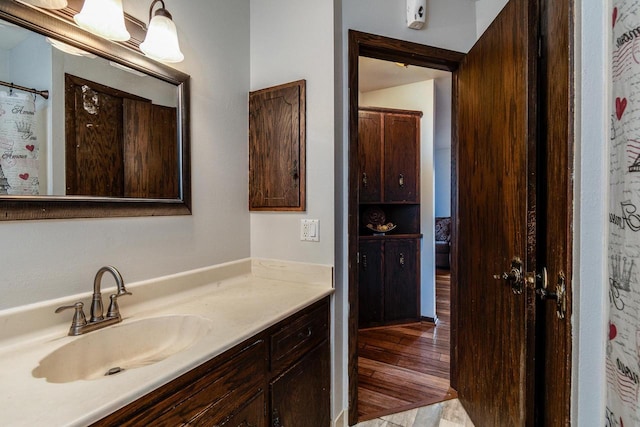 bathroom featuring a shower with curtain, vanity, and hardwood / wood-style flooring